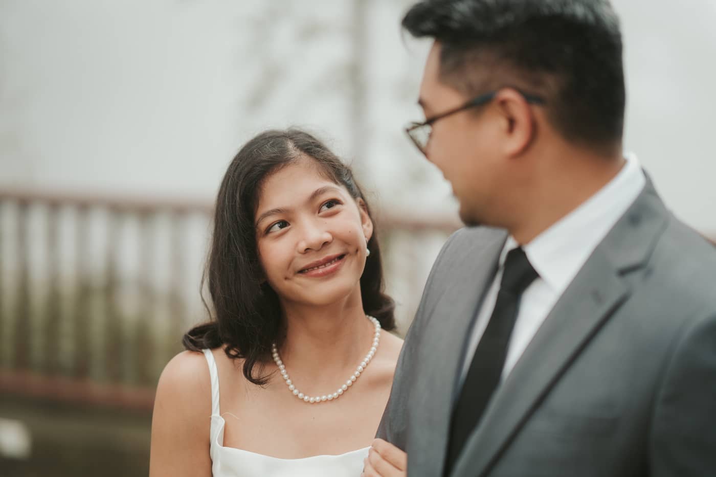 A close portrait of her smiling up at him