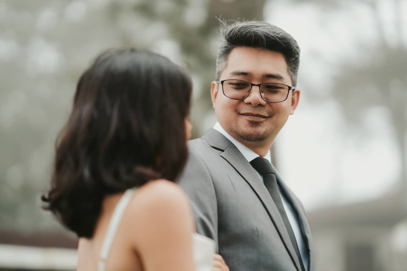 A close portrait of him smiling as he looks at her